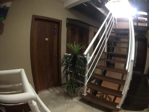 a staircase in a room with a chair and a lamp at GH Bizkaia in Florianópolis