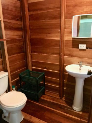 a bathroom with a toilet and a sink at Casita del Mar- Caribbean Beachfront Bungalow in Chiquita Beach in Puerto Viejo