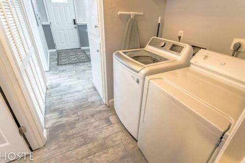 a washer and dryer in a room with a hallway at 2BR Garden-level Great Outdoors Dog Friendly in Colorado Springs