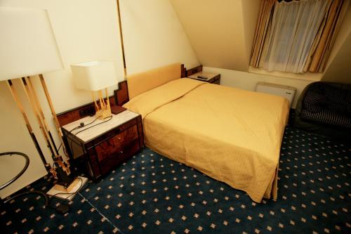 Ένα ή περισσότερα κρεβάτια σε δωμάτιο στο Hotel Podzamcze