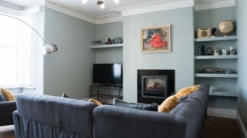 a living room with a couch and a fireplace at Kittiwake Number 4 - Town Centre & Spacious in Bridlington