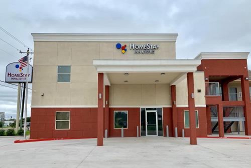 a hospital building with a sign on top of it at HomeStay Inn & Suites Edinburg in Edinburg
