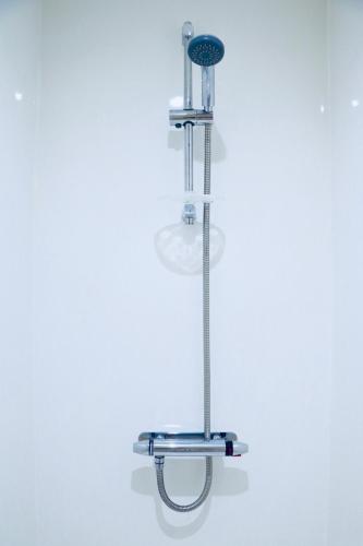 a light fixture hanging on a white wall at The Liverpool Pod Travel Hostel in Liverpool