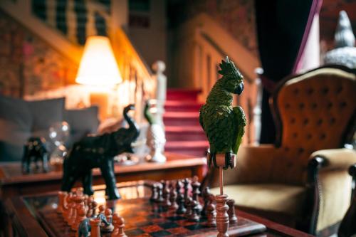 a chess board with a toy chicken on a table at Hôtel des Deux Clefs in Turckheim