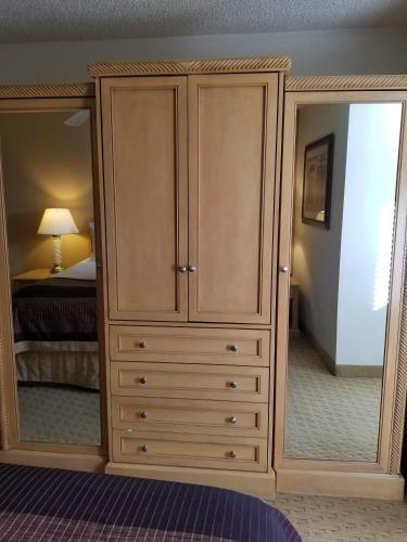 a large wooden cabinet with a mirror in a bedroom at Twin Peaks Lodge & Hot Springs in Ouray
