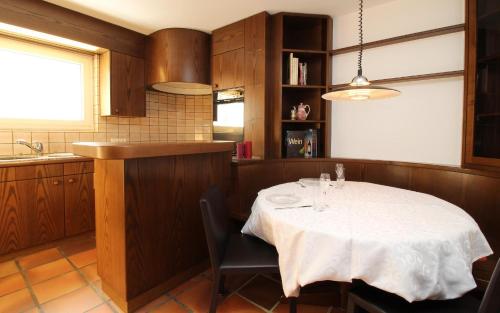 a kitchen with a table with a white table cloth at Chesa Alice in St. Moritz