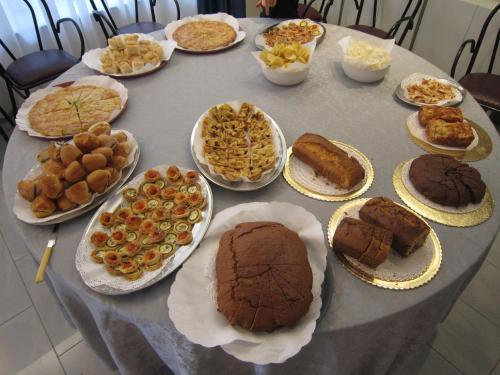 a table full of different types of cakes and pastries at Hotel San Francisco Spiaggia in Rimini