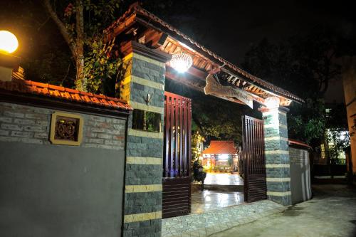 a building with a gate at night with lights at Hoang Giang Homestay in Ninh Binh