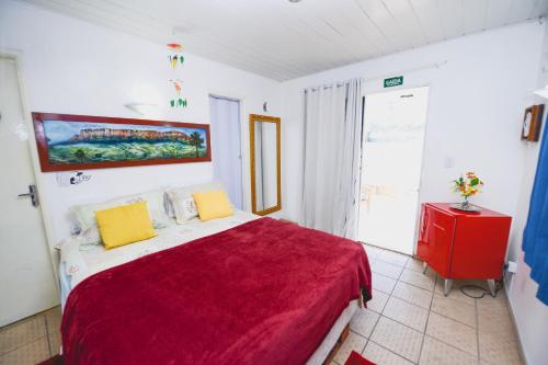 En eller flere senge i et værelse på Hotel Hostel Caçari
