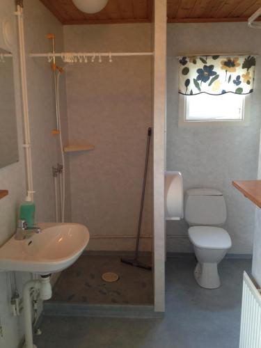 a bathroom with a toilet and a sink at Källviken Semesterby in Strömstad