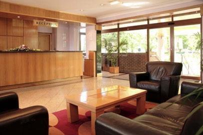 a lobby with couches and a coffee table in a hospital at Parkside International Hotel in Reading