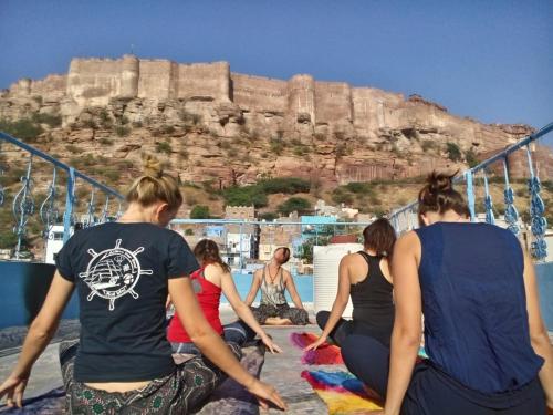 a group of women sitting on a boat looking at the acropolis at Yogis Guest House in Jodhpur