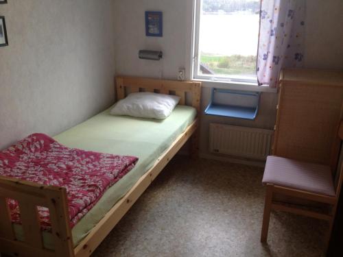 a small bedroom with a bed and a window at Källviken Semesterby in Strömstad
