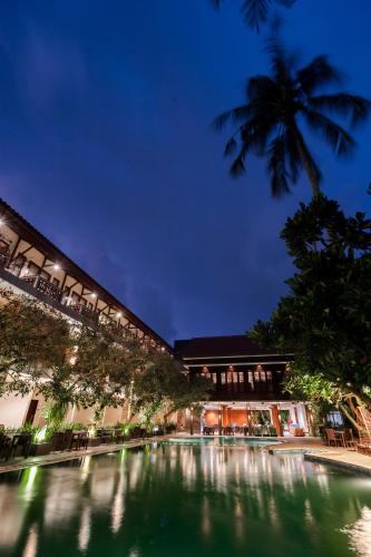 a building with a pool of water at night at Surya Kencana Seaside Hotel in Pangandaran