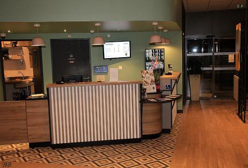 a store with a counter in a room at B&B HOTEL Bordeaux Centre Gare Saint-Jean in Bordeaux
