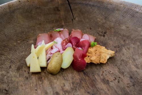 a plate of food with meats and cheese on a table at Boutique Hotel Kircher in Sarntal