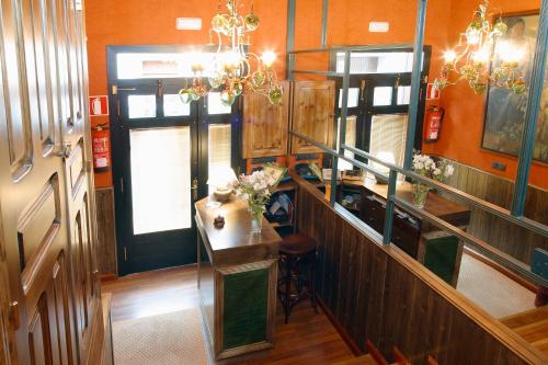 a kitchen with a counter and a table in a room at Hotel Avenida Real in Villaviciosa