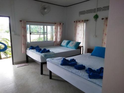 a bedroom with two beds and a window at Koh Phayam Greentawan Resort in Ko Phayam