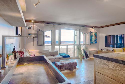 uma sala de estar com uma banheira no meio de um quarto em Le Grand Sillon - Le Georges em Saint Malo