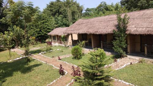 a house with a garden in front of it at Chital lodge in Chitwan