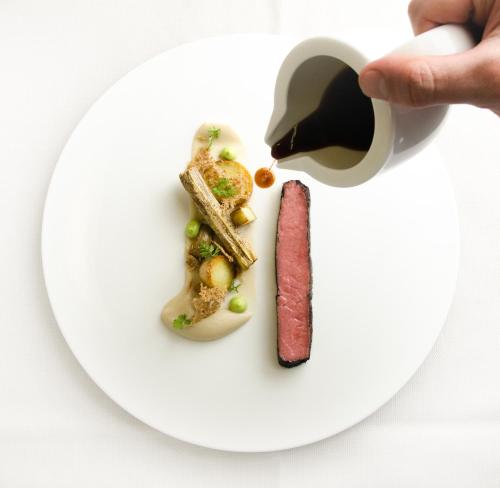 a white plate with a piece of food on it at Boutique Hotel Kircher in Sarntal