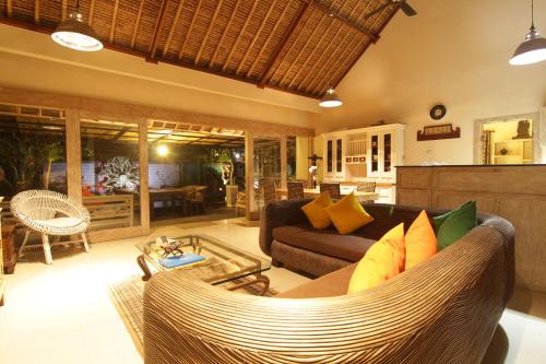 a living room with a couch and a table at Bamboo Moon Villas in Sanur