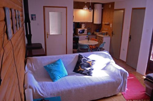 a living room with a couch with pillows on it at Cabin & Apartment Kopaonik in Kopaonik