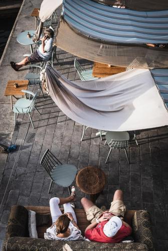 a group of people sitting around a patio with a hammock at MAZMI CASA in Dubai
