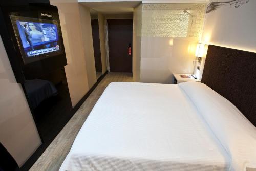 Ένα ή περισσότερα κρεβάτια σε δωμάτιο στο Two Hotel Buenos Aires