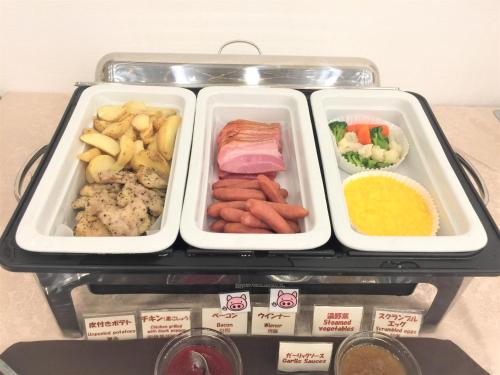 a refrigerator with three trays of different types of food at Kansai Airport First Hotel in Izumi-Sano