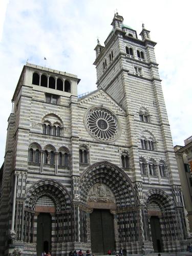 a large building with a tower and a clock at Domus Antiqua San Lorenzo in Genova