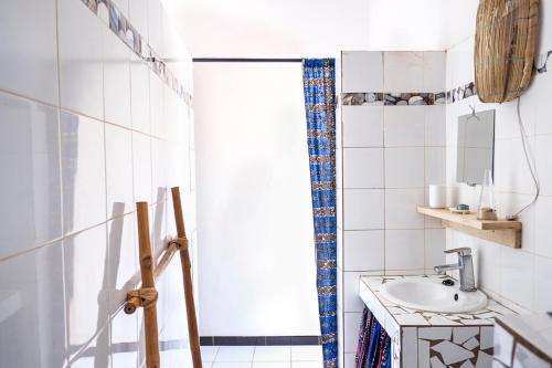 a bathroom with a sink and a mirror at Keur Dofie in Toubab Dialaw