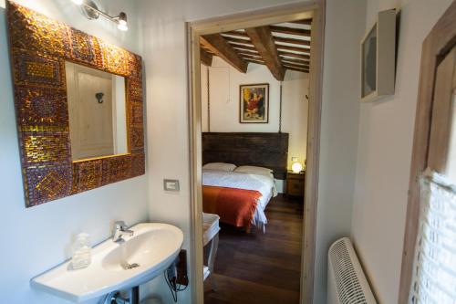 a bathroom with a sink and a bed in a room at Ca' Barbona in Lido di Classe