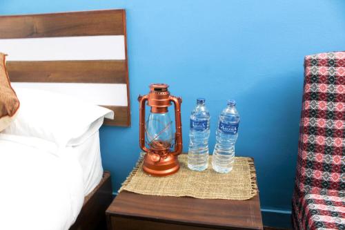 two bottles of water on a table next to a bed at Gorkha Chhen bed & breakfast in Gorkhā