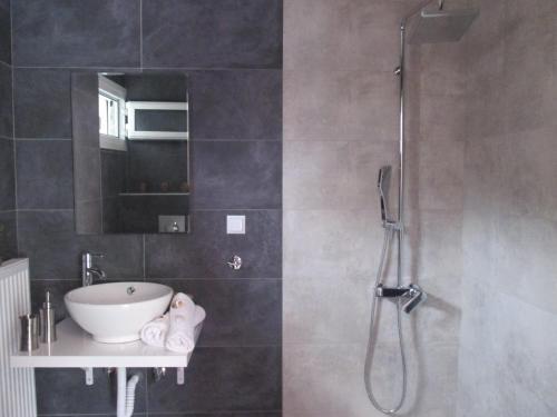 a bathroom with a shower and a sink at Selene's House in Skala Kallirachis