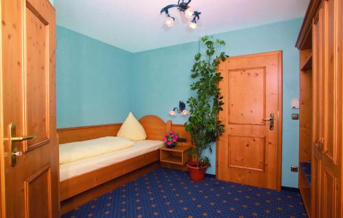 a room with a bed with a plant and a door at Landgasthof Schmidbaur in Donauwörth