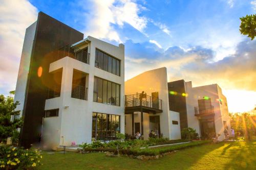 a large white building with a sunset in the background at Lin's Forest in Hengchun