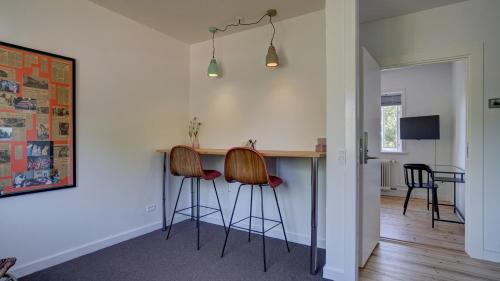 a kitchen with two bar stools at a counter at Villa Sofie Bed & Breakfast in Haslev
