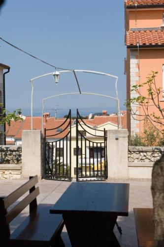 a patio with a black table and a fence at Apartments Valentino in Vrsar