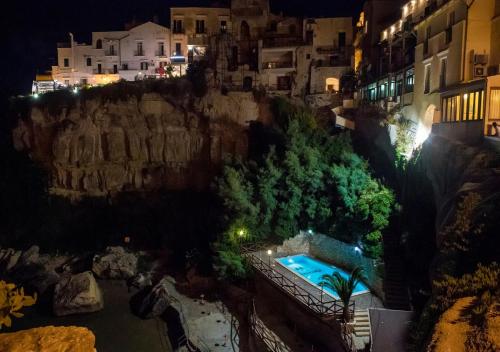 a view of a city at night with a swimming pool at Hotel Seggio in Vieste