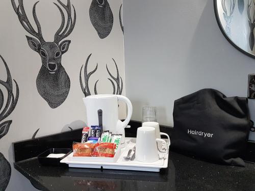 a tray of food and a coffee maker on a table at The Glebe Hotel in Liverpool