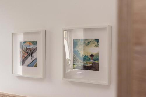 two framed photographs hanging on a wall at Metro Apartments Vienna in Vienna