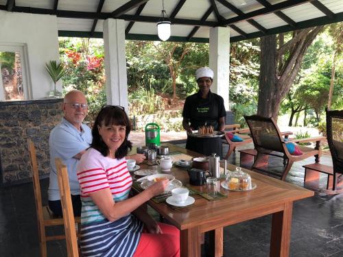 a man and a woman sitting at a table at Gammaduwa Heritage Bungalow and Tea Gardens in Matale