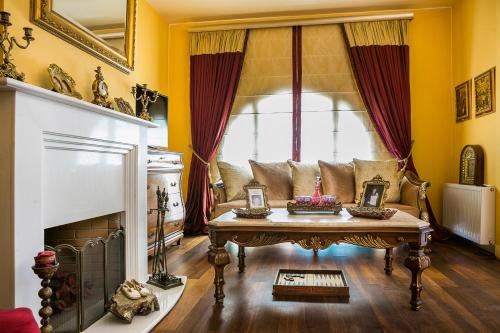 a living room with a couch and a fireplace at Palazzino Di Nionio in Karavadhos