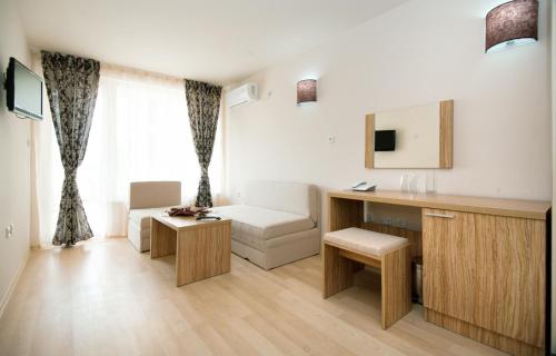 a living room with a desk and a chair at Karlovo Hotel in Sunny Beach