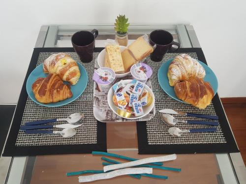 a table topped with plates of bread and pastries at B&B Musica e Mare in Naples