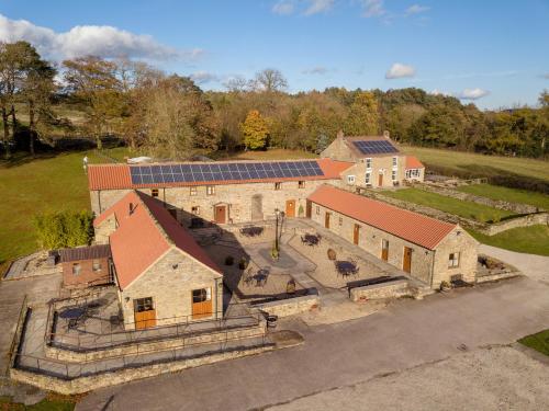 an aerial view of a building with solar panels on it at Rawcliffe House Farm in Pickering