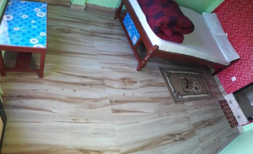 an overhead view of a hardwood floor with a bed at Begnas Coffee House & Hotel in Deorāli