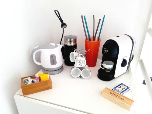 a shelf with appliances on top of a white cabinet at B&B Musica e Mare in Naples
