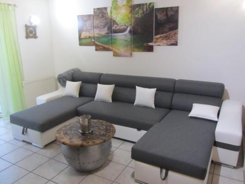 a living room with a couch and a table at Ferienwohnungen Fuchshuber in Neukirchen vorm Wald